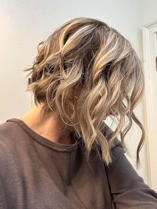 Reviewer's wavy hair after applying the spray
