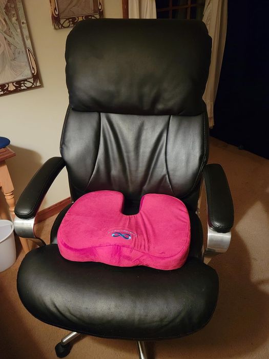 Reviewer's red seat cushion on a desk chair