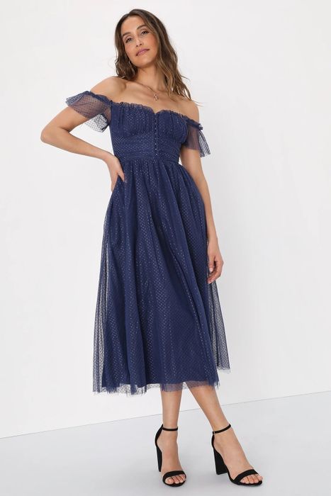 Model wearing a blue dress with black heels