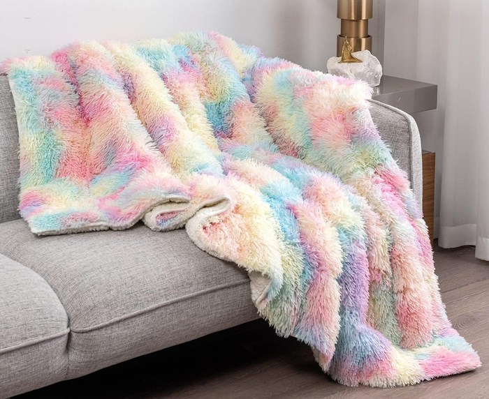 the blanket featuring a vibrant rainbow pattern