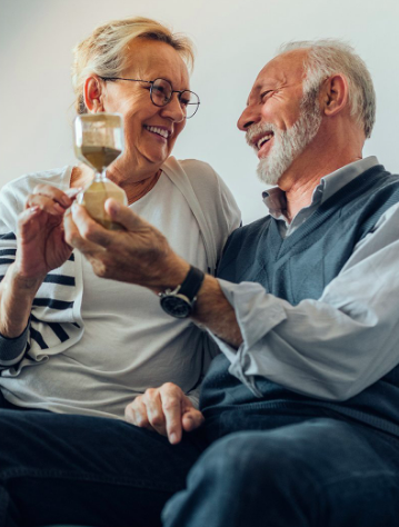 An elderly couple enjoying the game together, relishing the experience.