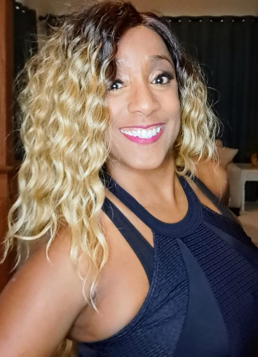 A reviewer showcasing their wavy, thick hair after using the spray