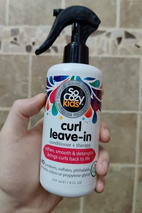 Reviewer holding the bottle of conditioner