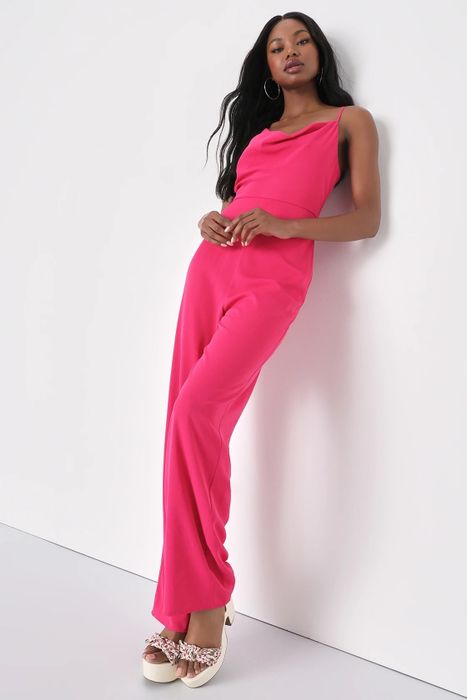 A model wearing a pink jumpsuit paired with white shoes.