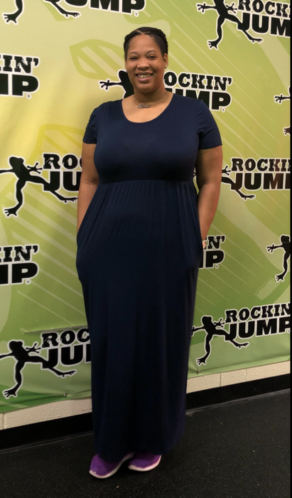 A reviewer wearing the black version of the dress