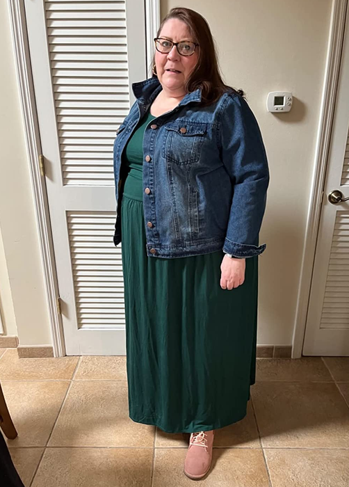 a reviewer wearing the same dress in green with a denim jacket layered over it
