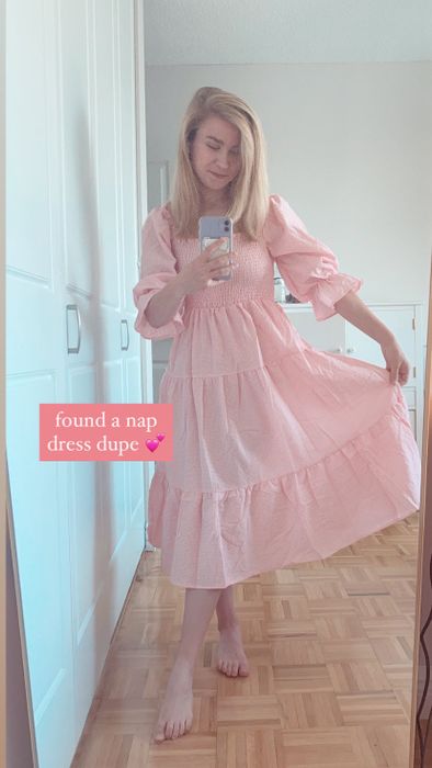 A Mytour editor in a pink and white gingham maxi dress with puff sleeves
