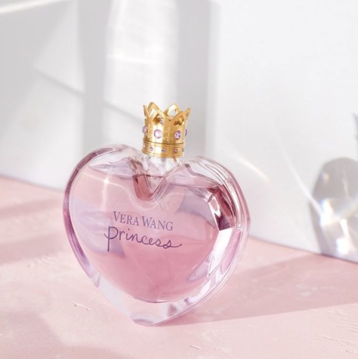 The perfume in a heart-shaped bottle with a crown-shaped screw-off lid
