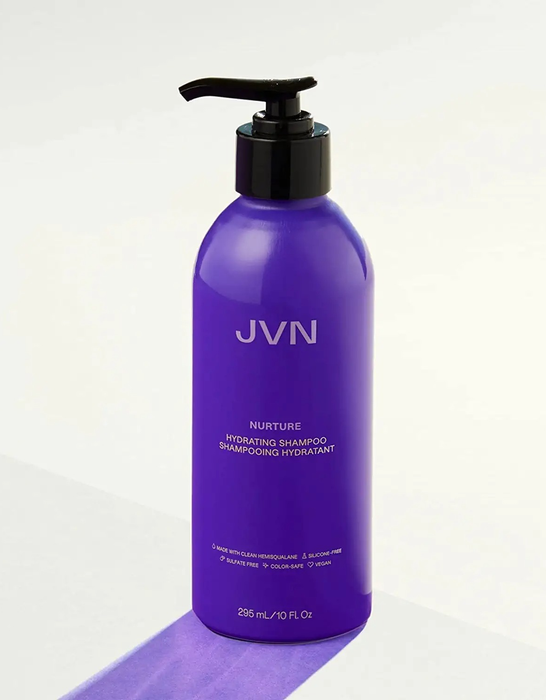 A purple shampoo bottle with a black pump, displayed on a white background.