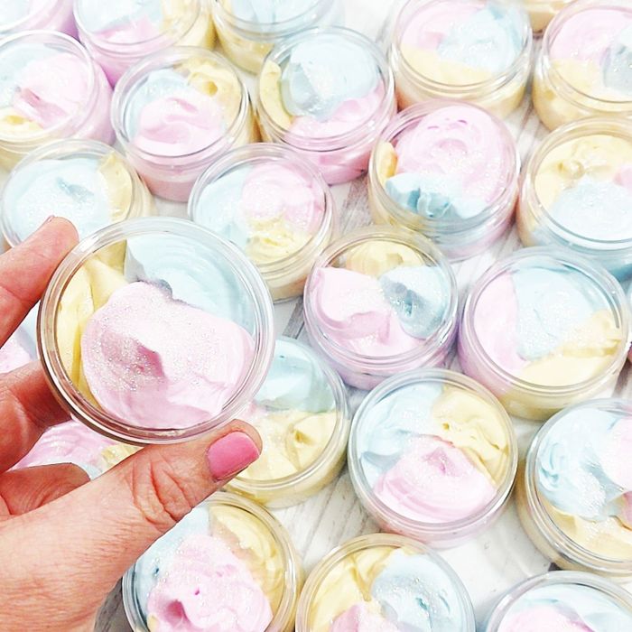 Small jars filled with rainbow-colored whipped cream