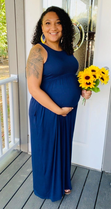a pregnant reviewer rocking the dress in a deep navy blue shade