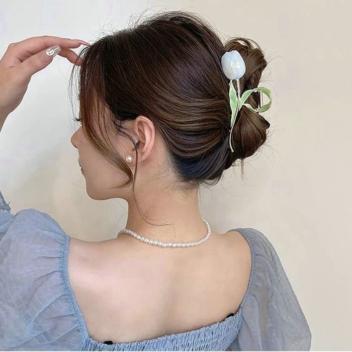 model wearing a blue tulip claw clip