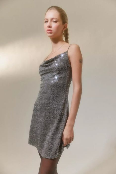 A close-up shot of the same model in the sequined mini dress.