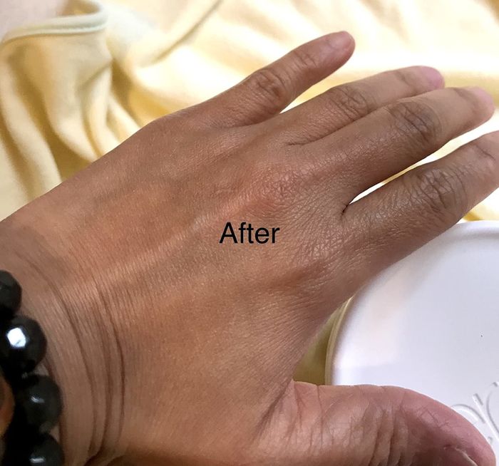A reviewer's photo of soft, moisturized hands after using the cream