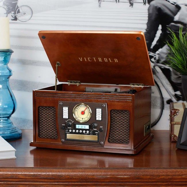A retro music system featuring a hinged top record player.