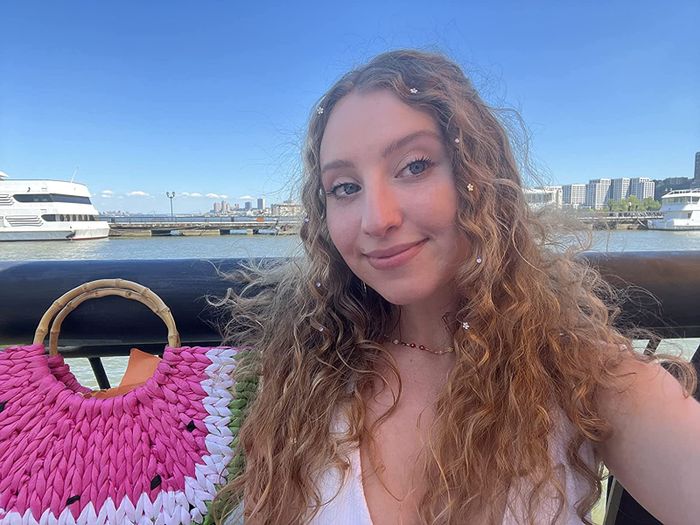 A reviewer rocking hair gems in their hair