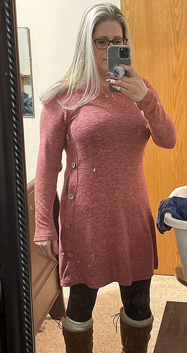 a reviewer wearing the knit dress in pink, styled with leggings