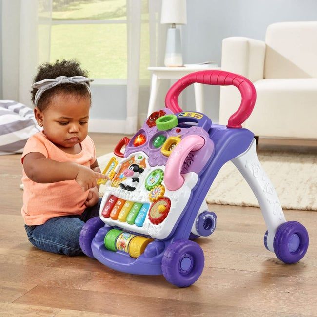 A baby playing with the sit-to-stand toy
