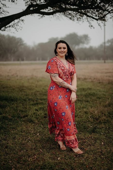 A reviewer wearing the red printed maxi dress