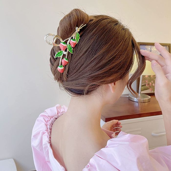 model styling a strawberry claw clip