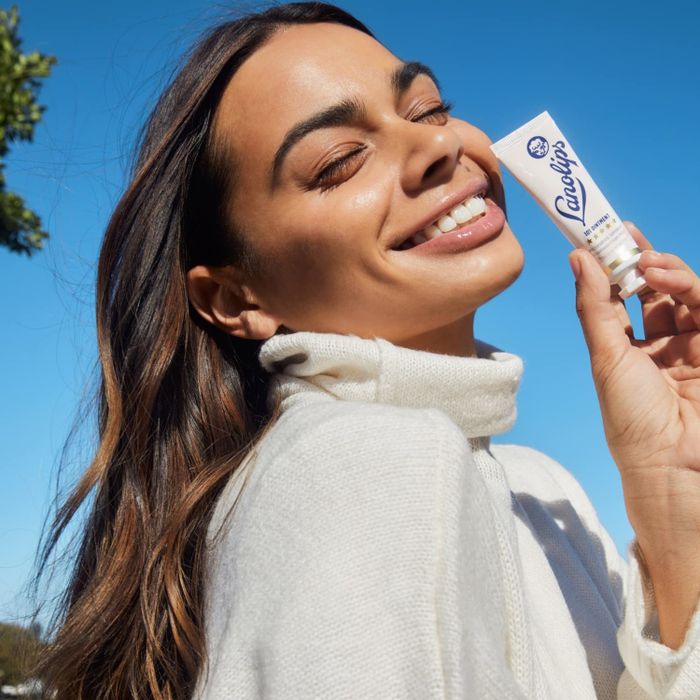 model holding a pink tube of Lanolips