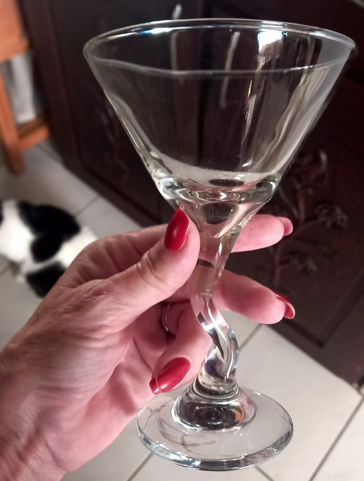 Another reviewer holds a glass up close for a detailed view.