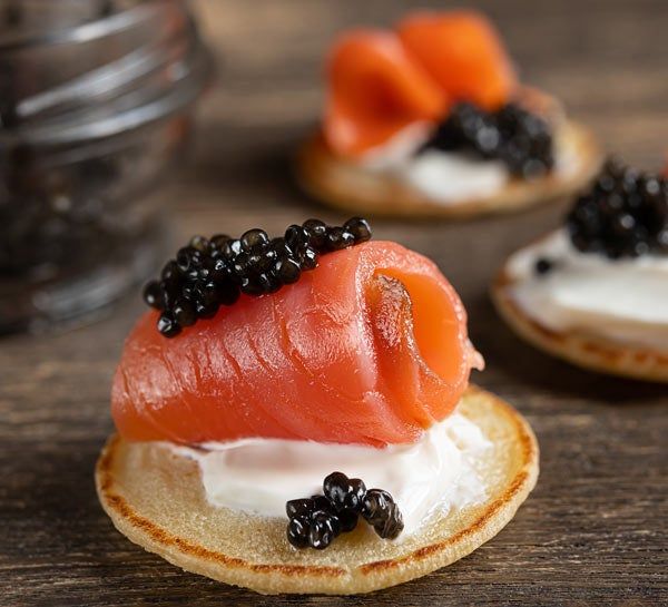 served piece of roe and blini with lox
