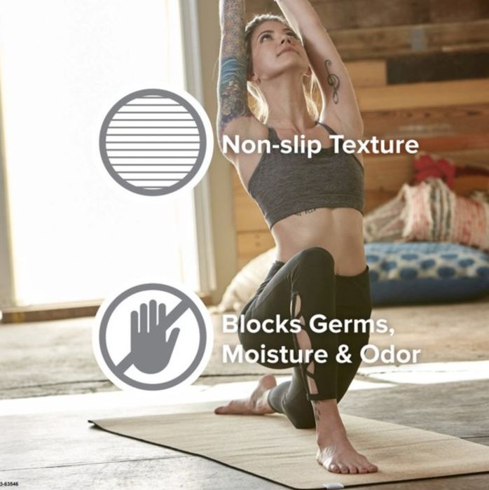 A model performing a low lunge on the cork mat, with text highlighting its nonslip surface and its ability to resist germs, moisture, and odors.