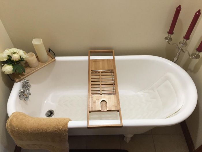 A photo of the bath pillow in use, floating in the tub.