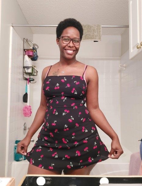 The reviewer is rocking a cherry print mini dress.