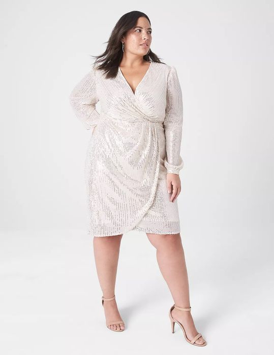 A model wearing the white sequined dress paired with heels.