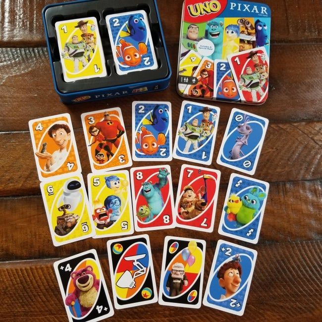 A deck of Uno cards featuring characters from Ratatouille, Finding Nemo, The Incredibles, Up, Toy Story, and more