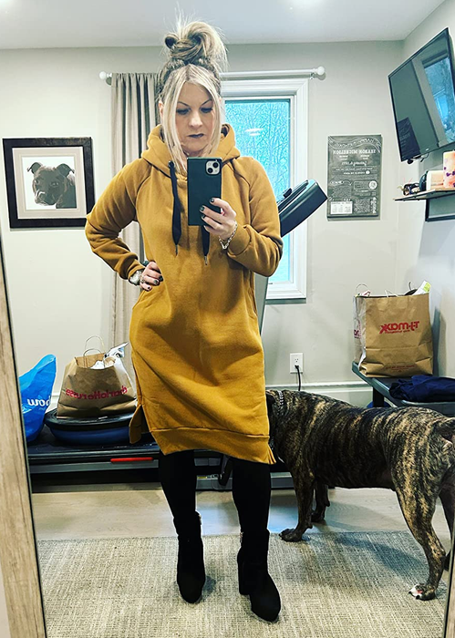 a reviewer rocking the same hooded dress in mustard yellow