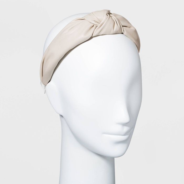 White mannequin sporting a white headband