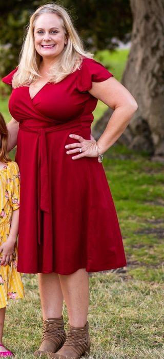 A reviewer wearing the red dress