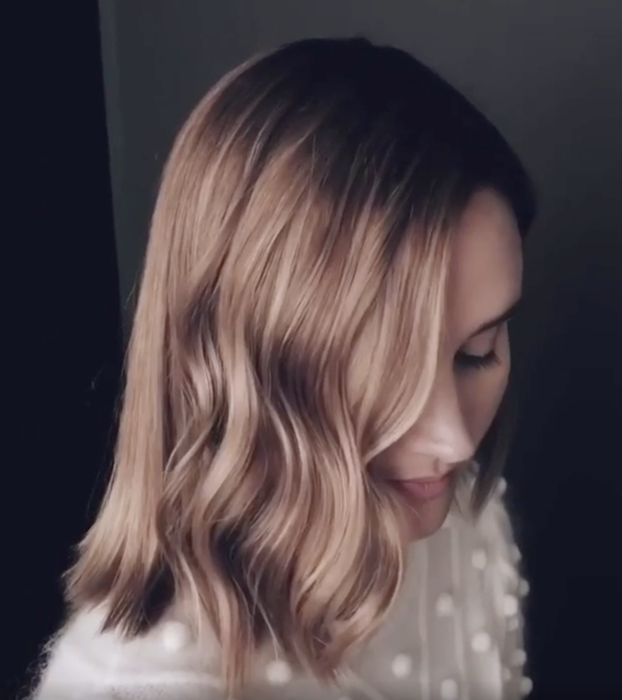 A model showcasing her hair after using the curling iron