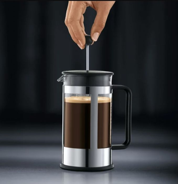 the French press filled with fresh coffee