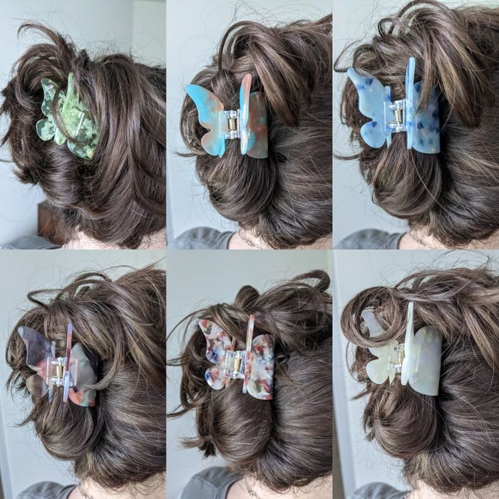 A reviewer showcasing how different colors of the butterfly clip appear in their hair