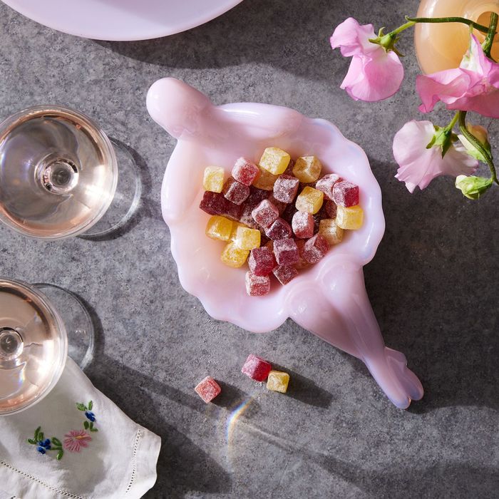 A closeup of the pink dish holding colorful candies.