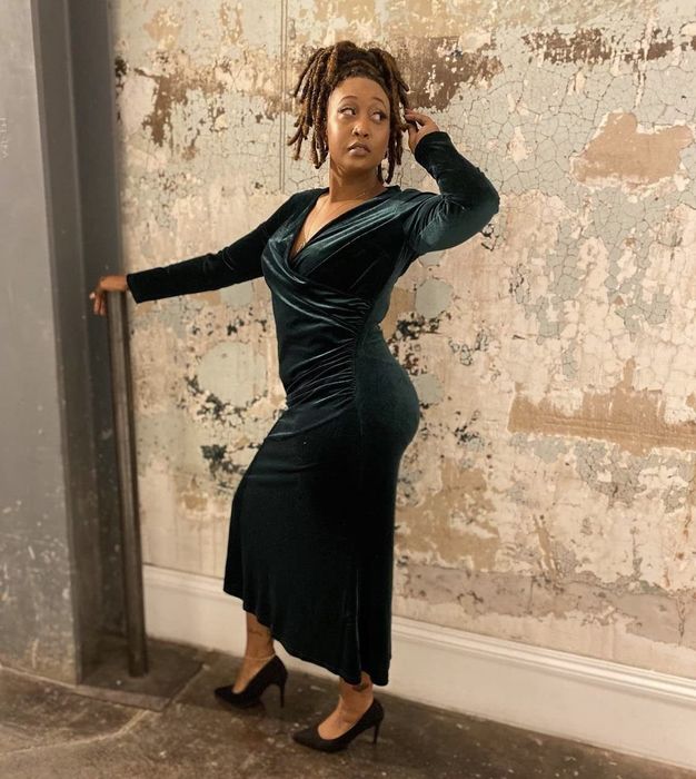 A reviewer showcasing the same dress, but in a sleek black shade.