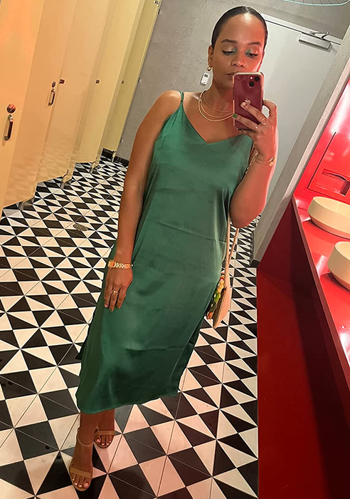 A reviewer wearing the green slip dress with tan heels.