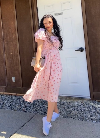 A reviewer in the pink version of the dress