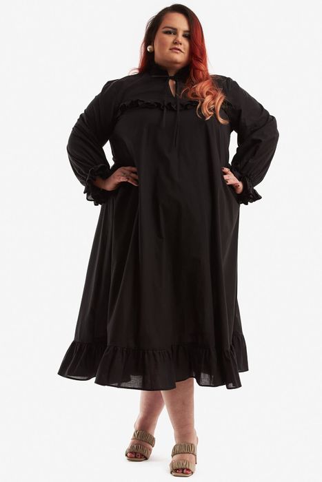 a model wearing a long-sleeve black nightgown with ruffle details