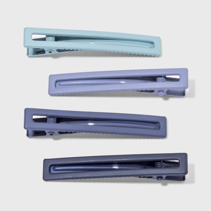 A set of four blue hair clips, each in a unique shade