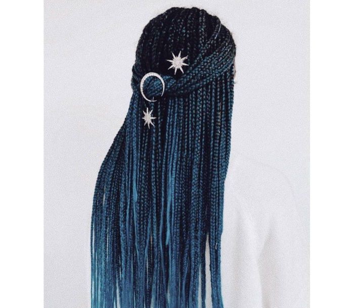 Model with blue and black hair adorned with silver star and moon hair accessories