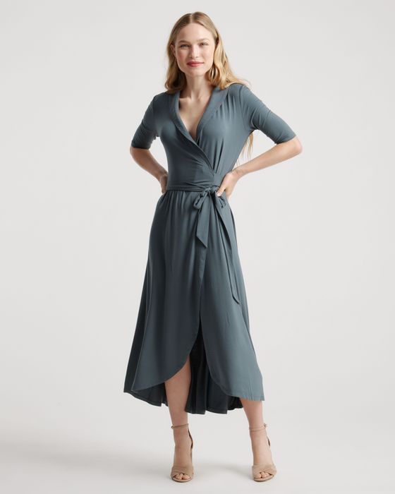 a model wearing a midi wrap dress in a soft dusty blue shade