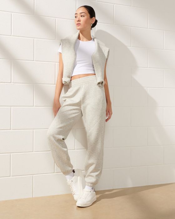 a model wearing light gray sweatpants paired with a cropped white T-shirt