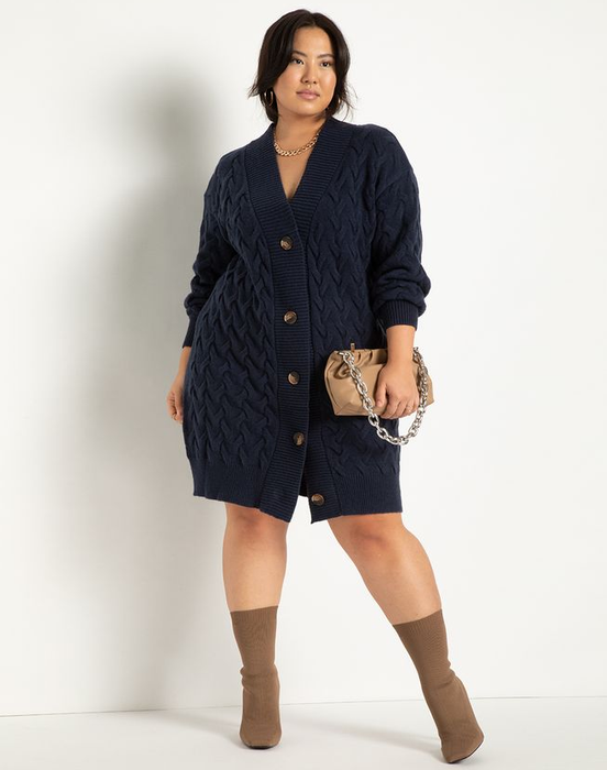 a model styling the same cardigan dress in navy with no shirt underneath