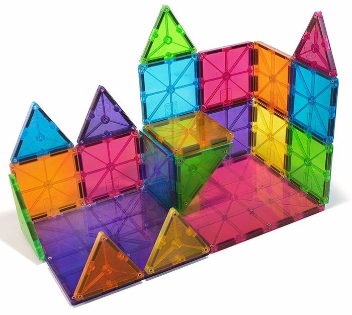 Multicolored magnetic tiles, both square and triangular, arranged into a towering structure