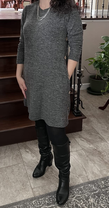 a reviewer styled in the gray dress, paired with black leggings and knee-high boots